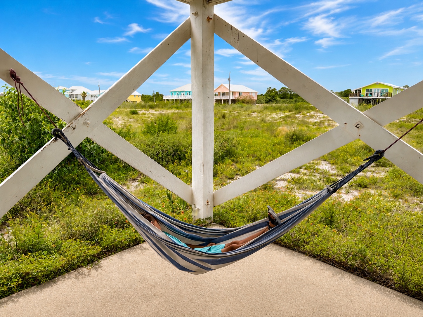 A guest relaxing in the shaded hammock beneath Good Tides Only